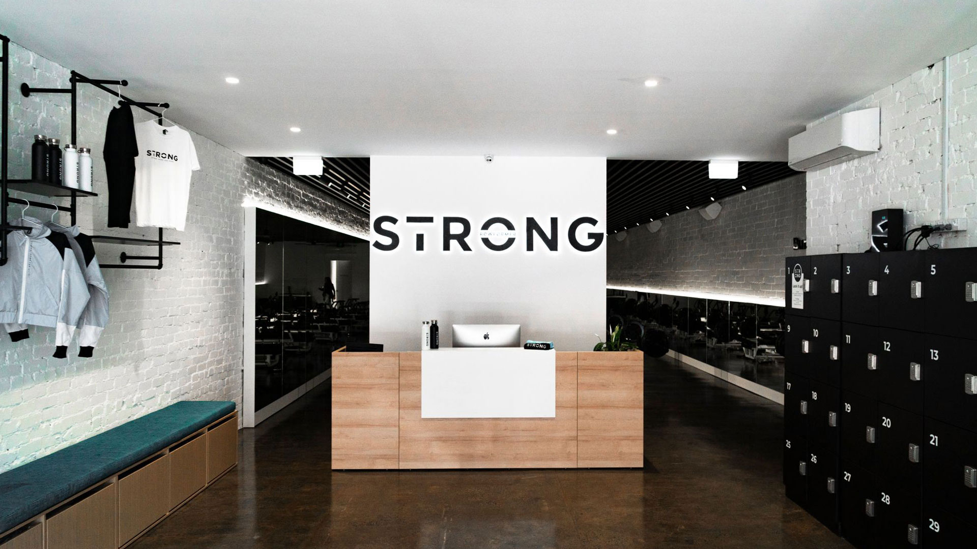 STRONG studio reception with front desk, merch rack and lockers